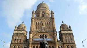 Front view of the iconic Brihanmumbai Municipal Corporation (BMC) headquarters building in Mumbai, India, with its Indo-Gothic architecture under a blue sky.